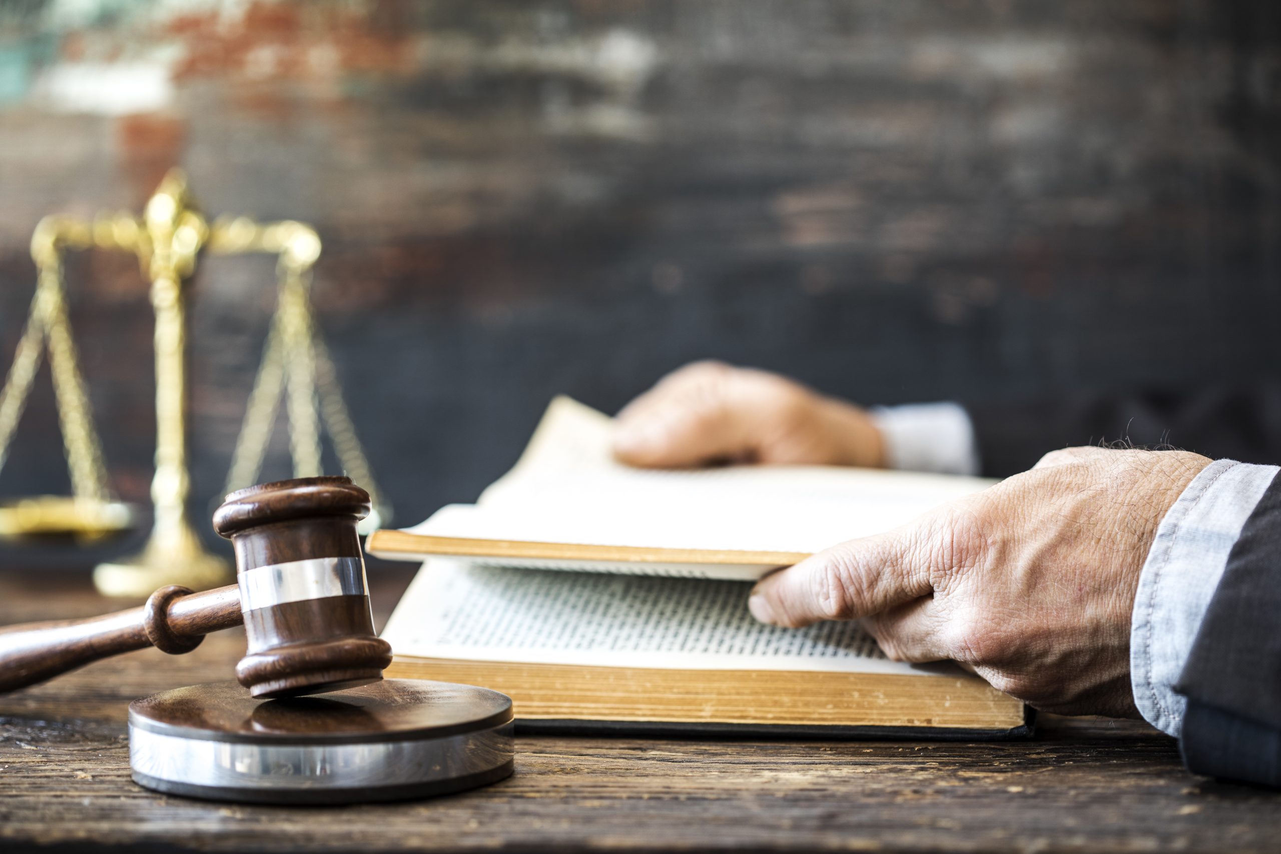 Man,Reading,Book,With,Gavel,And,Justice,Scale